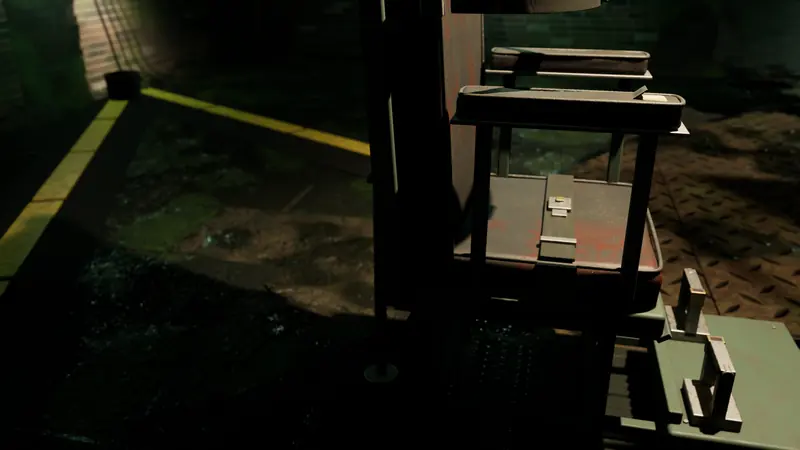 Close-up of a rusted console stand and a yellow safety line on the wet floor.